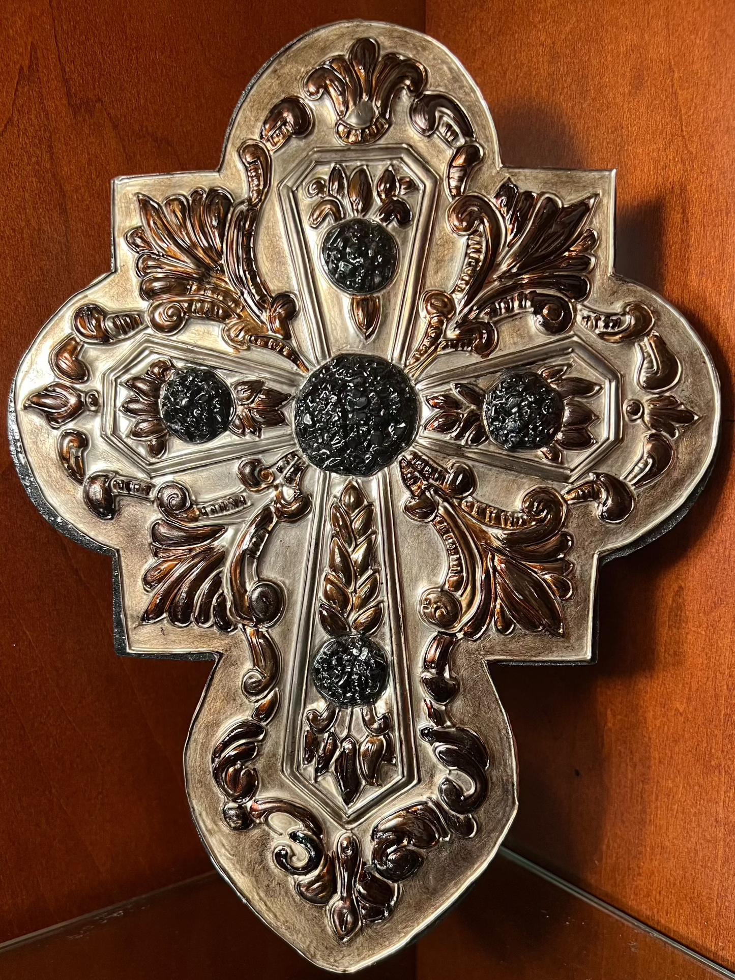This handcrafted medieval-style piece features a pewter cross, imported from Europe, mounted on a solid wooden base and accented with obsidian quartz. Each piece is uniquely crafted, ensuring no two are ever the same.

Approximate size: 10 1/2" tall × 9 1/2" wide.