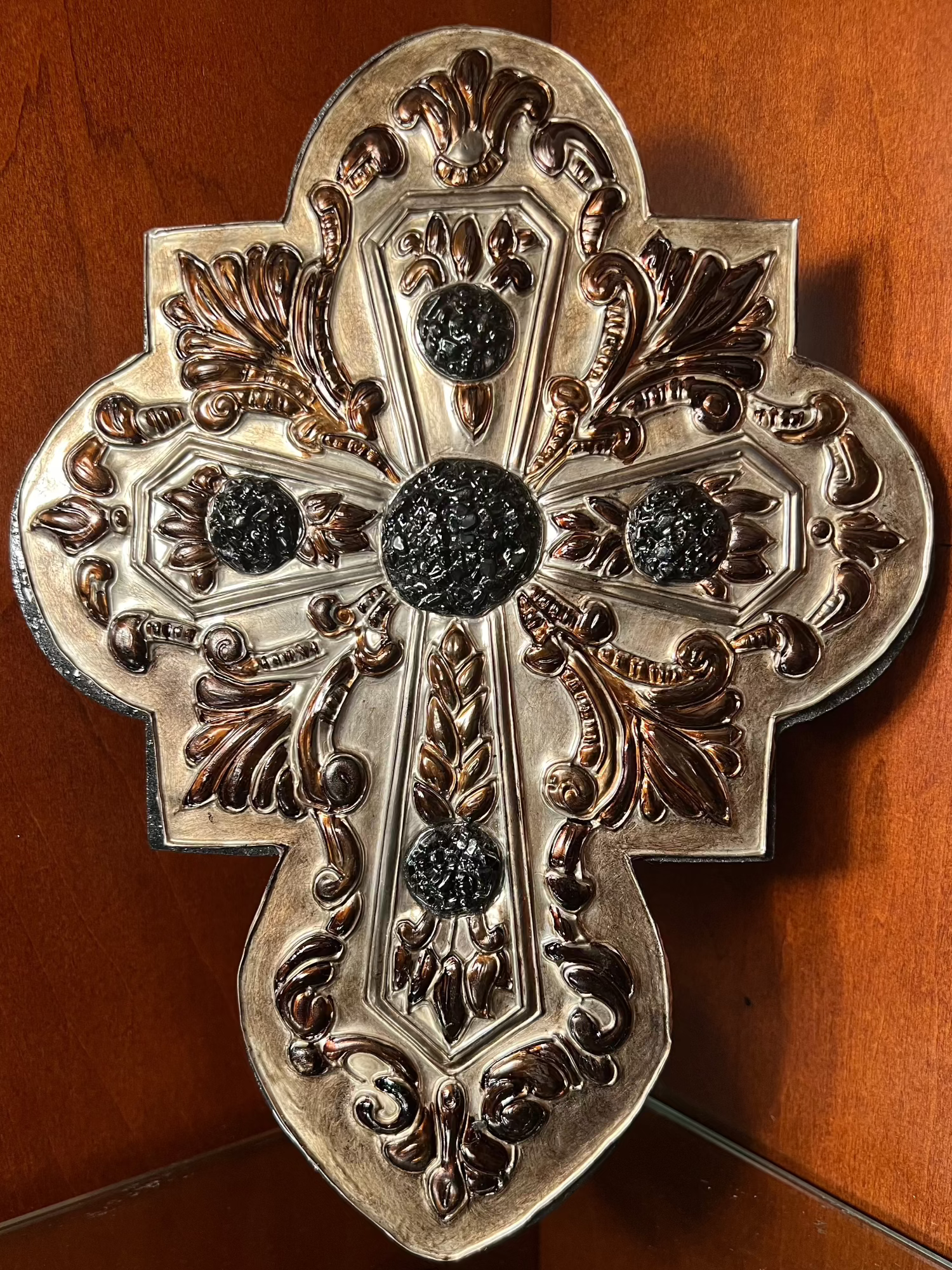 This handcrafted medieval-style piece features a pewter cross, imported from Europe, mounted on a solid wooden base and accented with obsidian quartz. Each piece is uniquely crafted, ensuring no two are ever the same.

Approximate size: 10 1/2" tall × 9 1/2" wide.